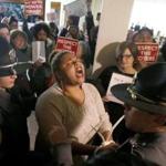 A protester shouted as she was arrested during a special session of the North Carolina General Assembly on Friday.