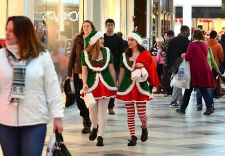 Elves Tara Foley, 17, from Pembroke, and Sarah Roman, 17, from Norwell, make the rounds as costumed greeters at the South Shore Plaza. Debee Tlumacki for the Boston Globe 
