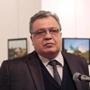 The Russian Ambassador to Turkey Andrei Karlov speaks a gallery in Ankara Monday Dec. 19, 2016. A gunman opened fire on Russia's ambassador to Turkey Karlov at a photo exhibition on Monday. The Russian foreign ministry spokeswoman said he was hospitalized with a gunshot wound. The gunman is seen at rear on the left. (AP Photo/)