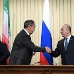 Russian Foreign Minister Sergei Lavrov (C) shakes hands with his Turkish counterpart Mevlut Cavusoglu (R) as Iran's Foreign Minister Mohammad Javad Zarif (L) looks on after a news conference in Moscow on December 20, 2016. The foreign and defence ministers of Russia, Turkey and Iran are meeting in Moscow for key talks on the conflict in Syria. Iran and Russia are sharing a base in war-torn Syria to help coordinate their support for President Bashar al-Assad's forces, a top security official in Tehran said on December 20. / AFP PHOTO / Natalia KOLESNIKOVANATALIA KOLESNIKOVA/AFP/Getty Images