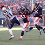 Denver CO 12/18/16 New England Patriots Julian Edelman hauls in a reception with pressure from Denver Broncos Corey Nelson (52) and Kavon Webster during second quarter action at Sports Authority Field at Mile High Stadium (Photo by Matthew J. Lee/Globe staff) topic: Patriots-Broncos reporter: