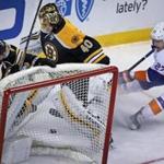 Boston, MA: 12-20-16: When the Bruins Brad Marchand (63) collided with his goalie Tuukka Rask behind the net in the first period, it created an opening for the Islanders Anders Lee (27) and he took full advantage, as he reached his stick across Rask and slipped the puck over the line for a 1-0 New York lead. The Boston Bruins hosted the New York Islanders in a regular season NHL game at the TD Garden. (Globe Staff Photo/Jim Davis) reporter: dupont topic: Bruins-Islanders