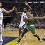 Boston Celtics guard Isaiah Thomas (4) drives to the basket between Memphis Grizzlies center Marc Gasol (33) and guards Tony Allen (9) and Mike Conley, right, during the second half of an NBA basketball game Tuesday, Dec. 20, 2016, in Memphis, Tenn. (AP Photo/Brandon Dill)