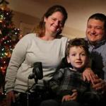 Seven-year-old Matthew Davidopoulos, who has spinal muscular atrophy, posed for a portrait with his parents Courtney and Paul at their home in Westford.