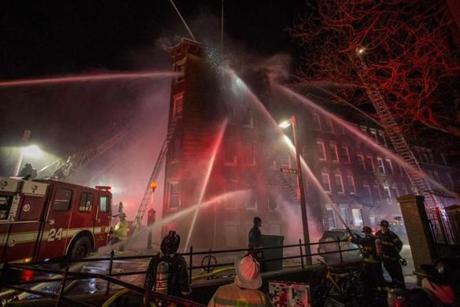 Boston Fire works to surround and extinguish a 5-alarm fire at 52 Hull St. in the North End early on Sunday, December 25, 2016. (Scott Eisen for The Boston Globe)
