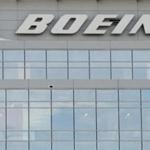 The logo of Boeing is seen on Boeing's Government Operations office in Arlington, Virginia on December 13, 2016. Wall Street stocks rose early Tuesday as the Dow advanced to within striking distance of 20,000 points shortly before the start of a two-day Federal Reserve monetary policy meeting. Boeing dipped 0.1 percent as it announced it will cut production on its 777 aircraft next year, a move that will impact an unspecified number of jobs. The aerospace giant also said it was lifting its quarterly dividend 30 percent to $1.42 per share and authorizing additional share repurchases to allow up to $14 billion. / AFP PHOTO / SAUL LOEBSAUL LOEB/AFP/Getty Images