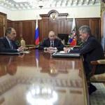 Russian President Vladimir Putin, center, and Foreign Minister Sergey Lavrov, left, listen to Defence Minister Sergei Shoigu in Moscow, Russia on Thursday, Dec. 29, 2016. Putin is ordering to scale down the Russian military presence in Syria. Putin made the statement Thursday while declaring that a cease-fire in Syria brokered by Russia and Turkey will start at midnight. (Mikhail Klimentyev/Sputnik, Kremlin Pool Photo via AP)