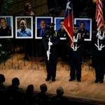 An honor guard stood in front of images of the five Dallas officers slain during an attack earlier this year during a memorial service.