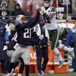 New England Patriots cornerback Malcolm Butler (21) goes up to intercept a pass intended for New York Jets wide receiver Robby Anderson (11) during the first half of an NFL football game, Saturday, Dec. 24, 2016, in Foxborough, Mass. (AP Photo/Charles Krupa)