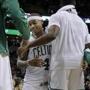 Boston Celtics guard Isaiah Thomas (4) is congratulated by teammates at the bench in the finals moments of an NBA basketball game against the Miami Heat, Friday, Dec. 30, 2016, in Boston. (AP Photo/Elise Amendola)