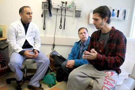 Boston, MA., 12/20/16, Ben Blake, 26, right, and his father Duane Blake, cq, meet with his doctor Parsia A. Vagefi, cq,. Ben was expected to die within months without a liver transplant. As it became clear he was too far down the wait list to get one in time, Mass. General surgeons came up with an unusual plan: take a liver from a donor with hepatitis C and then give Ben super powerful new hepatis C drugs after the transplant to cure the disease. It is the first such transplant at MGH but doctors predict the approach is poised to take off nationally for liver, kidney, heart and lung transplants. Alot of organs from donors with hepatitis C are currently discarded. Ben had his transplant a week or so ago. Suzanne Kreiter/Globe staff)
