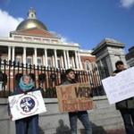 Demonstrators outside the Mass. State House protested against delaying the opening date for recreational marijuana stores by half a year, from January to July 2018.  
