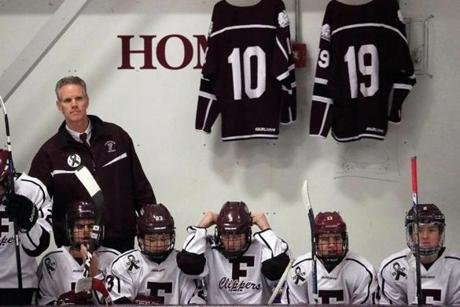 Falmouth, MA - 1/04/2017 - Falmouth head coach Paul Moore behind the bench. The Falmouth High boys' hockey team plays its first game since a car accident claimed the lives of players Owen Higgins and James Lavin. - (Barry Chin/Globe Staff), Section: Sports, Reporter: David Souza, Topic: 05falmouth, LOID: 8.3.1191073667.
