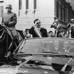SANTIAGO, CHILE - OCTOBER 1: Chilean President Salvador Allende (C) wawes to their supporters in Santiago a few days after his election 24 October 1970. The car with Allende is escorted by General Augusto Pinochet (L). (Photo credit should read STF/AFP/Getty Images)