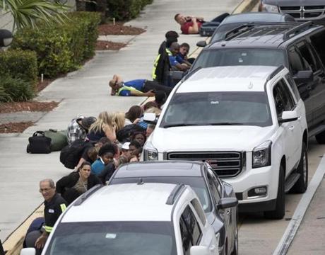 People took cover outside Fort Lauderdale?s airport.
