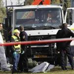 Police officers inspected the scene after a truck rammed through a group of Israeli cadets in Jerusalem.