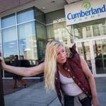 Sherry Gardner, a homeless woman, leaned against a light post in front of the Cumberland Farms store in April 2016.