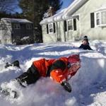 East Bridgewater, MA -- 1/8/2017 - Damon McNamee, 4, rolls in a snowbank in his front yard as he plays with his two and a half year old brother, Ethan, (R) in East Bridgewater where snow totaled 20.5 inches. (Jessica Rinaldi/Globe Staff) Topic: 09snow Reporter: 