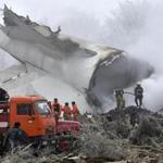 Emergency crews work near the smoldering remains of the cargo plane after Monday?s crash.