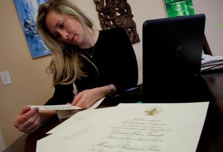 Jessica Beeson Tocco, a political consultant at A10 Associates in Wakefield, looks over inauguration tickets at her home on January 16, 2017. Tocco is going to the inauguration and helping clients secure tickets. Mark Lorenz for The Boston Globe
