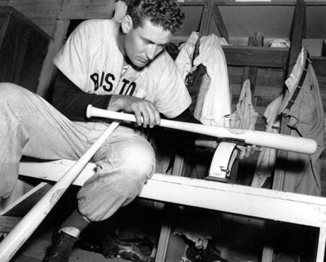 FILE - In this March 16, 1948 file photo, Boston Red Sox Ted Williams weighs one of his new 36-ounce Hickory baseball bats in the clubhouse after morning workout at spring training in Sarasota, Fla. Fans can see hundreds of items once owned by Red Sox slugger Ted Williams at a preview of the first major auction of his sports, military and personal memorabilia during a public preview starting Wednesday, April 25, 2012, through Friday at Fenway Park. The auction will be Saturday and some of the proceeds will benefit The Jimmy Fund, the official Red Sox charity. (AP Photo)
