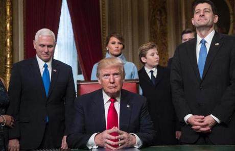US President Donald Trump is joined by the Congressional leadership and his family before formally signing his cabinet nominations into law, in the President's Room of the Senate, at the Capitol in Washington,DC on January 20, 2017. From left are Vice President Mike Pence, the president's wife Melania Trump, their son Barron Trump, and Speaker of the House Paul Ryan, R-WI. / AFP PHOTO / POOL / J. Scott ApplewhiteJ. SCOTT APPLEWHITE/AFP/Getty Images
