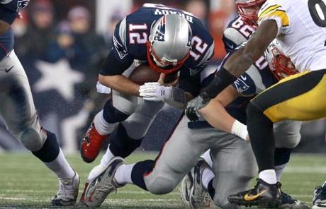 Tom Brady dove forward during a quarterback sneak in the third quarter. 
