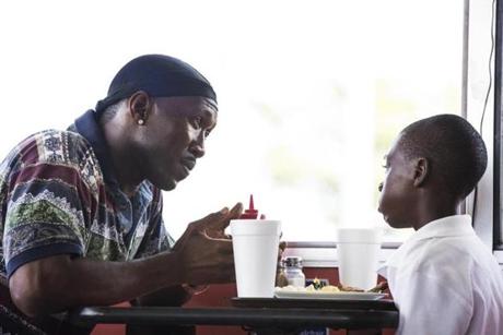 This image released by A24 Films shows Mahershala Ali, left, and Alex Hibbert in a scene from, 