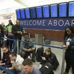 Delta passengers waited out delays Sunday at Hartsfield-Jackson International Airport in Atlanta.