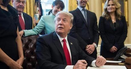 President Donald Trump was surrounded by business leaders in the Oval Office while signing an executive action Monday. 
