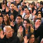 Close to 350 people were sworn in as US citizens during a ceremony at Faneuil Hall.