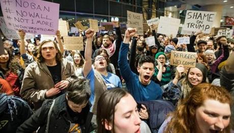 Demonstrators at Logan Airport protested against the ban Tuesday. 
