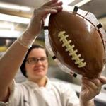 Chocolatier Angela Ernst made a chocolate football at Phillips Candy House in Dorchester Friday. 