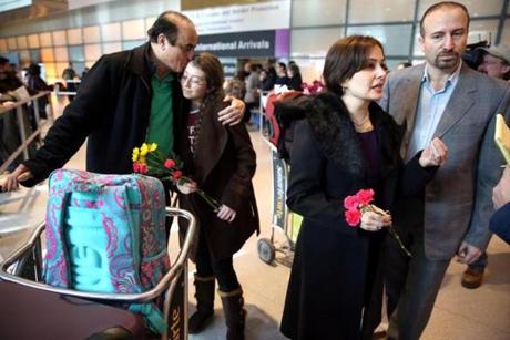 Ali Reza Jalili of Bedford. N.H., greeted his niece Haniya Jalili, 12, while his brother Hamid Reza Jalili and his wife, Baharehsadat Khamesi, spoke with a translator after arriving on a flight from Iran at Logan International Airport.
