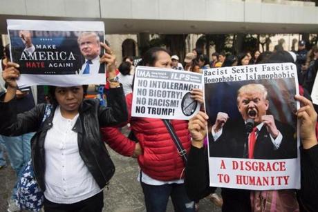 Protesters who object to President Trump?s travel ban held signs Sunday in Hong Kong in front of the US consulate.
