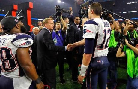 Roger Goodell shook hands with Tom Brady.
