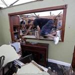 Gregory Rugon climbed through the ruins of his home in east New Orleans after failing to find the pair of glasses he lost while taking cover from the tornado.