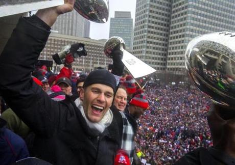 Tom Brady and Bill Belichick hoisted up Lombardi Trophies.
