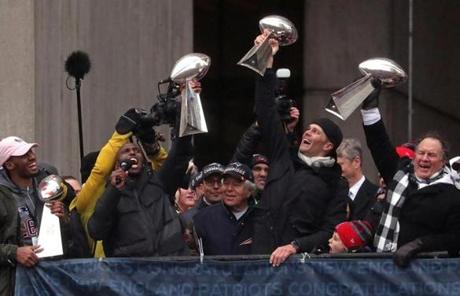 Boston, MA - 2/07/2017 - New England Patriots quarterback Tom Brady, New England Patriots head coach Bill Belichick, New England Patriots free safety Devin McCourty, hoist the Lombardi Championship trophies during today's rally ending at city hall. The New England Patriots are celebrated during a victory parade in Boston. - (Barry Chin/Globe Staff), Section: Metro, Reporter: Globe Staff, Topic: 08parade, LOID: 8.3.1553838056.

