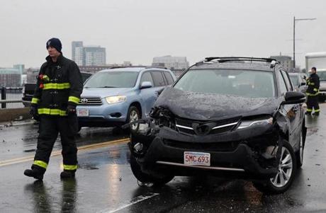 Boston, MA- February 08, 2017: Emergency workers clear an accident on the Harvard Bridge in Boston, MA on February 07, 2017. Authorities are responding numerous crashes with multiple vehicles around Eastern Massachusetts Wednesday, forcing them to close several major highways due to severe icy conditions during the morning commute. (Globe staff photo / Craig F. Walker) section: metro reporter:
