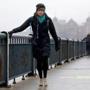 Laura Reid, a Boston University student, holds onto the railing while crossing an icy Harvard Bridge on Wednesday.