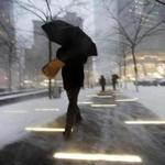 A man makes his way through wind and snow in New York's Zuccotti Park, Thursday, Feb. 9, 2017. A powerful, fast-moving storm swept through the northeastern U.S. Thursday, making for a slippery morning commute and leaving some residents bracing for blizzard conditions. (AP Photo/Mark Lennihan)