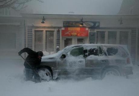 A man shovelled out his car on Main St in Plymouth on Thursday. 
