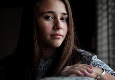 Averi Kaplowitch, 16, at her Marblehead home. She was troubled by images posted by classmates of a swastika made out of pennies.
