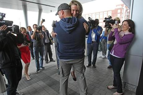 When Marathon amputee Roseann Sdoia was released from Spaulding, Mike Materia (center) was there to greet her.
