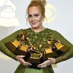 Adele posed with the five Grammys she won.