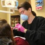Paulette Glasser, a dental hygienist, at work in Burlington in 2015.