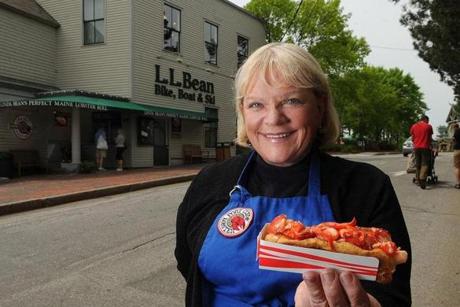 Linda Bean posed with one of her lobster rolls in 2009. Bean, who hoped to trade on her family?s famous last name to build her operation, has mostly retreated from the business.
