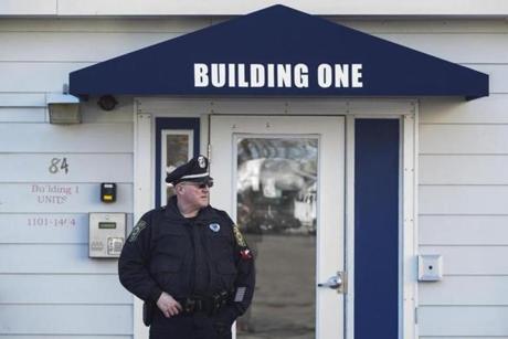A police officer stood in front of the apartment building in Peabody where a man was arrested in connection with a double homicide. 
