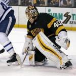 Boston Bruins goalie Tuukka Rask (40) looks to make a save through the legs of a Toronto Maple Leafs player during the first period of an NHL hockey game in Boston, Saturday, Feb. 4, 2017. (AP Photo/Mary Schwalm)